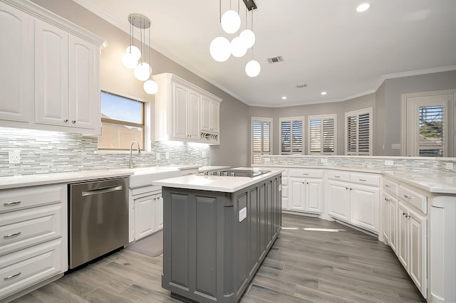 kitchen with white cabinetry, dishwasher, pendant lighting, black stovetop, and a kitchen island