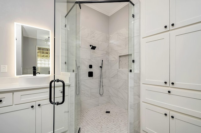 bathroom featuring a shower with door, ornamental molding, and sink