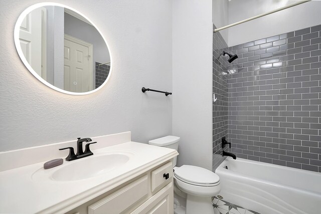 full bathroom with vanity, toilet, and tiled shower / bath