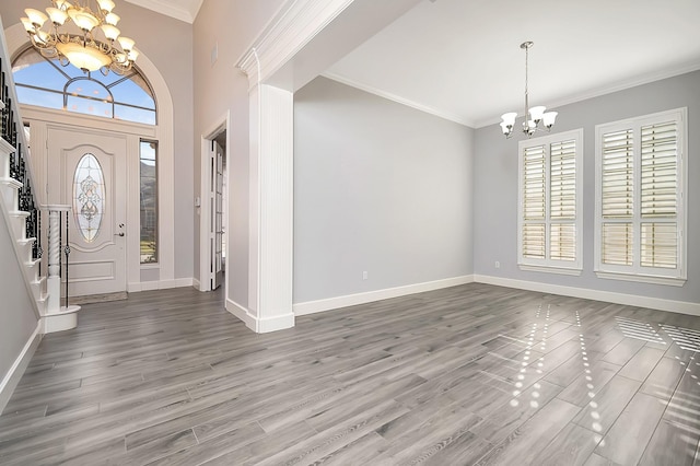 entrance foyer featuring a chandelier, hardwood / wood-style flooring, and plenty of natural light