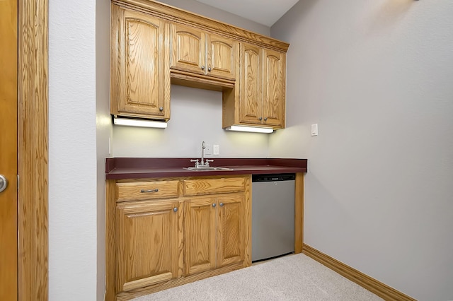 kitchen featuring light colored carpet, stainless steel dishwasher, and sink