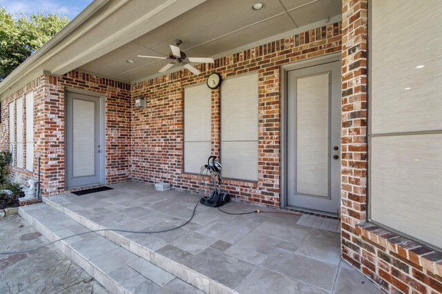 doorway to property featuring ceiling fan