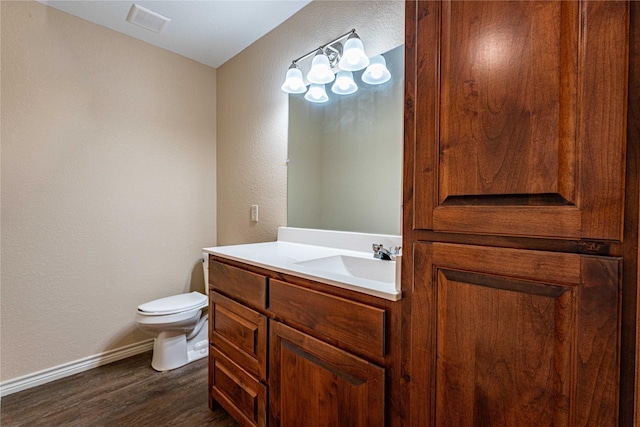 bathroom featuring vanity, toilet, and hardwood / wood-style floors