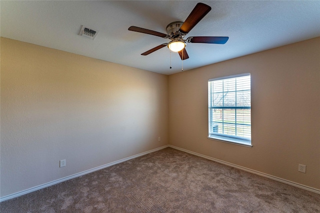 empty room featuring carpet flooring and ceiling fan