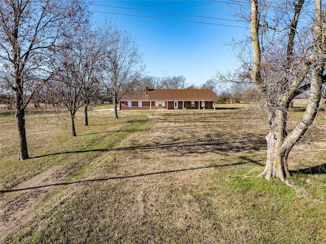 ranch-style home featuring a front lawn