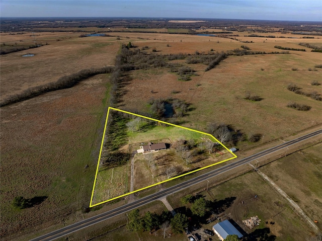 birds eye view of property with a rural view