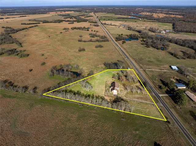 birds eye view of property with a rural view