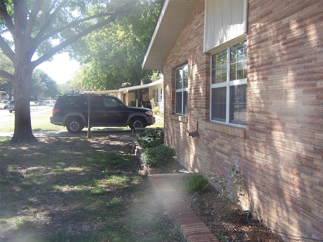 view of side of home with a carport