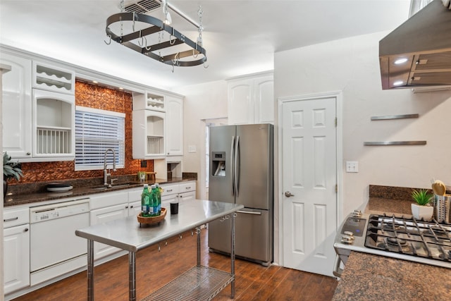 kitchen featuring white cabinetry, sink, dark hardwood / wood-style floors, dark stone countertops, and appliances with stainless steel finishes