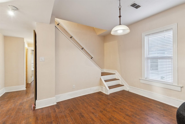 unfurnished living room featuring dark hardwood / wood-style flooring