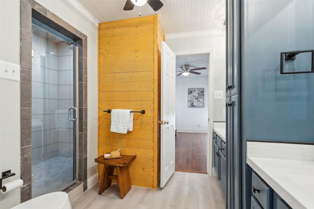 bathroom featuring wooden walls, vanity, ornamental molding, and hardwood / wood-style flooring