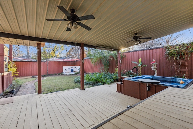 wooden deck featuring ceiling fan and a yard