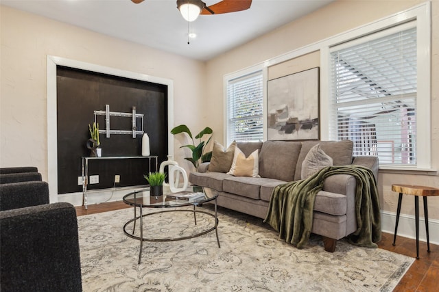 living room featuring hardwood / wood-style floors and ceiling fan