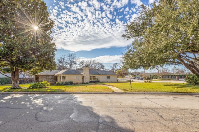 ranch-style house with a front lawn
