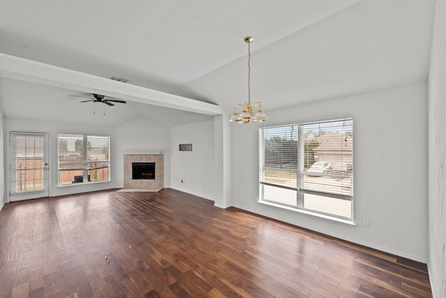 unfurnished living room featuring dark hardwood / wood-style flooring, vaulted ceiling, and a wealth of natural light