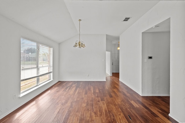 empty room featuring a notable chandelier, dark hardwood / wood-style flooring, and vaulted ceiling