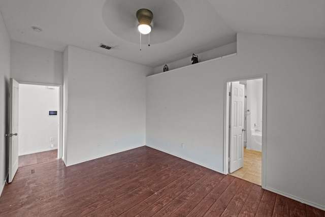 empty room featuring hardwood / wood-style flooring, vaulted ceiling, and ceiling fan