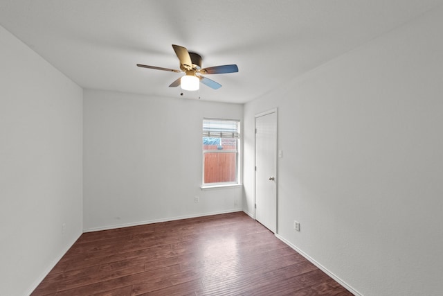 spare room featuring dark hardwood / wood-style floors and ceiling fan