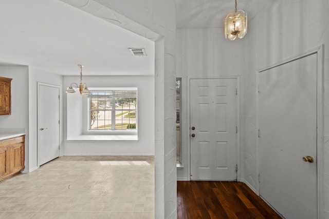 entryway featuring light hardwood / wood-style floors and a chandelier