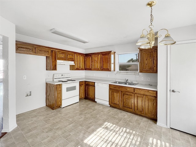 kitchen featuring pendant lighting, white appliances, sink, and a chandelier