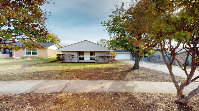 ranch-style house with a garage and a front lawn