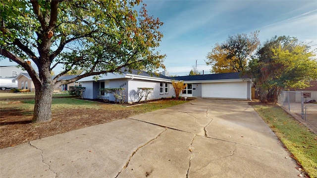 ranch-style home with a garage and a front lawn