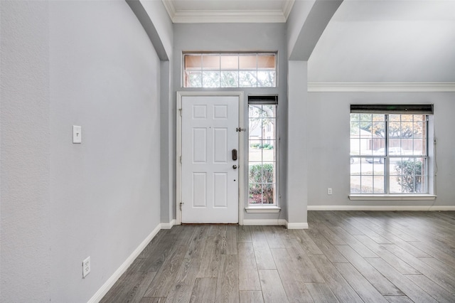 foyer entrance with hardwood / wood-style floors and ornamental molding