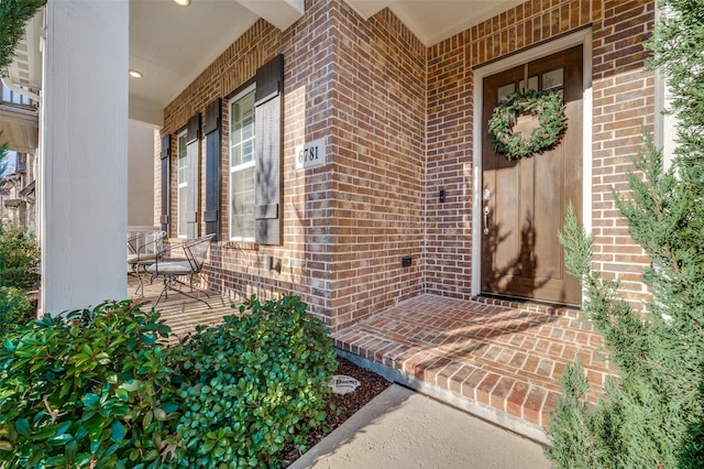 view of exterior entry with covered porch