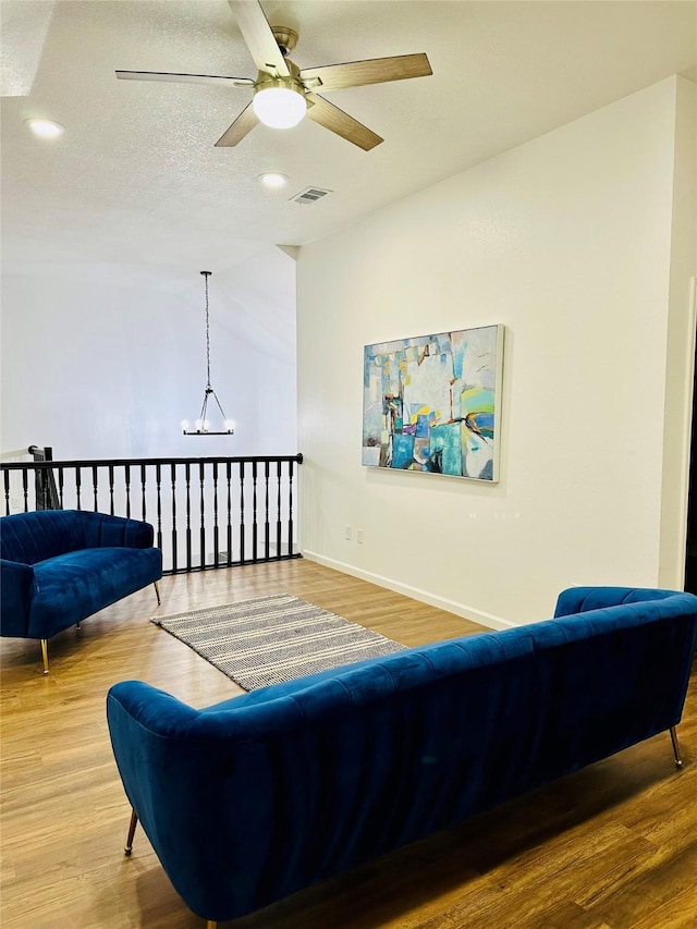 living room with hardwood / wood-style floors and ceiling fan