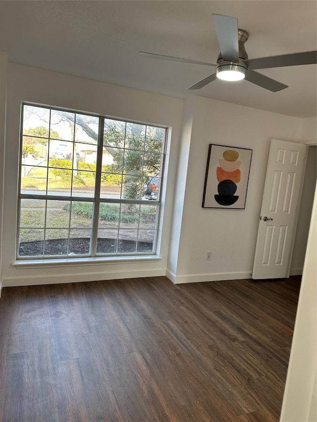 unfurnished room with ceiling fan and dark hardwood / wood-style floors