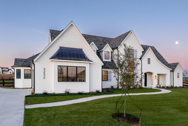 view of front of property with a lawn