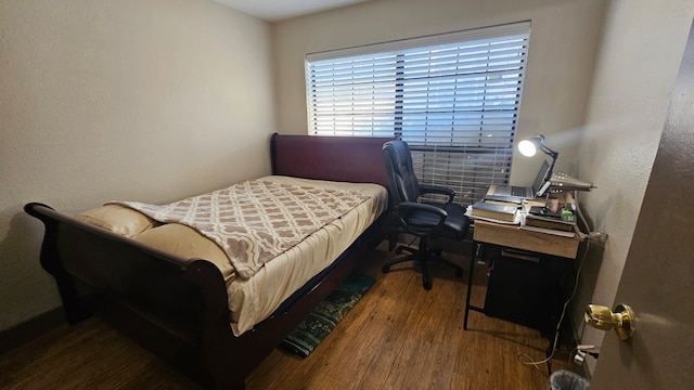 bedroom with dark wood-type flooring