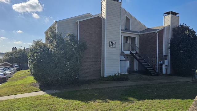 view of side of home featuring a yard