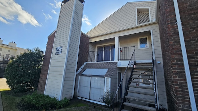 rear view of house with covered porch