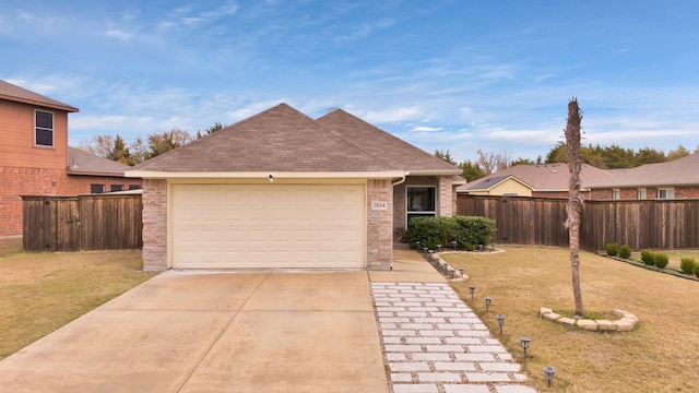 view of front facade with a front yard and a garage