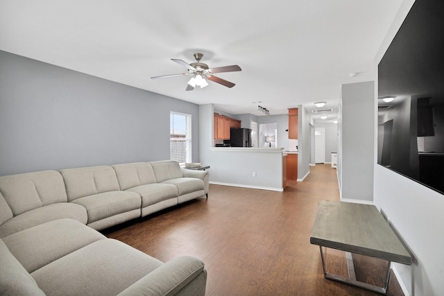 living room featuring hardwood / wood-style flooring and ceiling fan