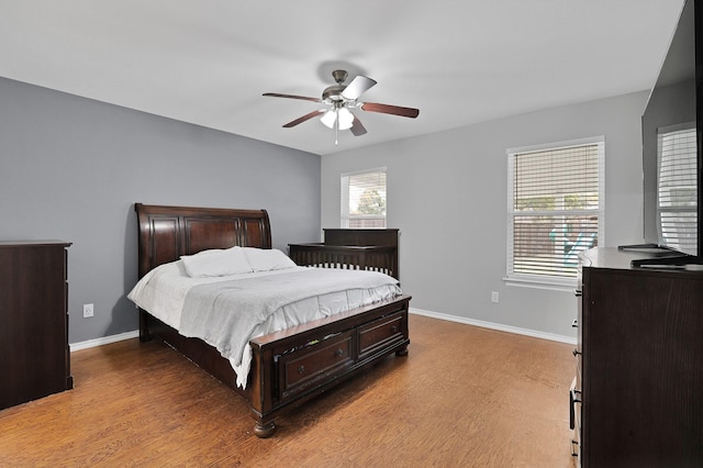 bedroom with light hardwood / wood-style flooring and ceiling fan