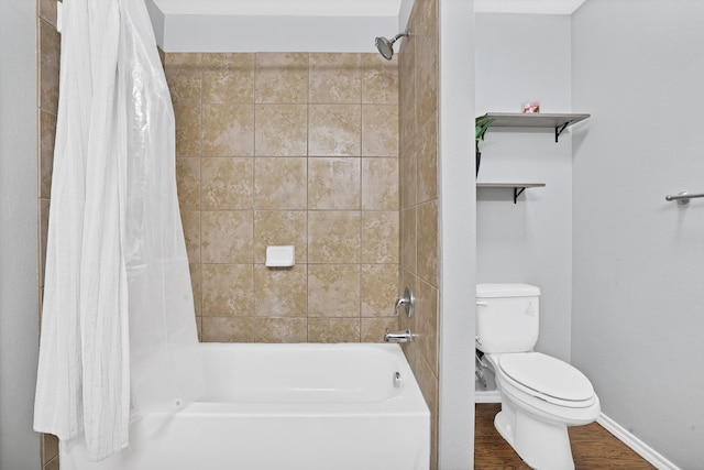 bathroom featuring shower / bathtub combination with curtain, hardwood / wood-style floors, and toilet