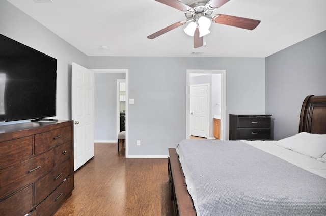 bedroom with ceiling fan, connected bathroom, and dark hardwood / wood-style floors