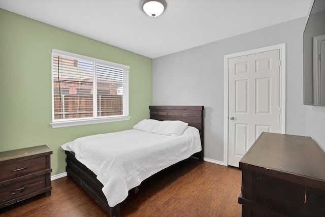 bedroom with dark hardwood / wood-style floors