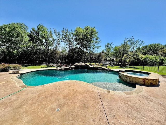 view of swimming pool featuring a patio, fence, and a pool with connected hot tub