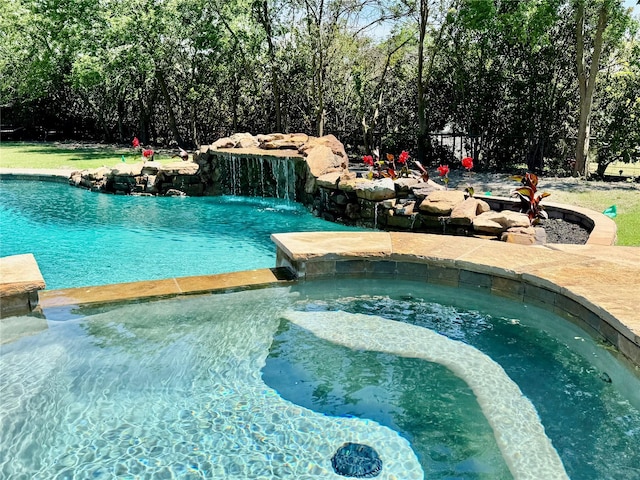 view of pool featuring a pool with connected hot tub