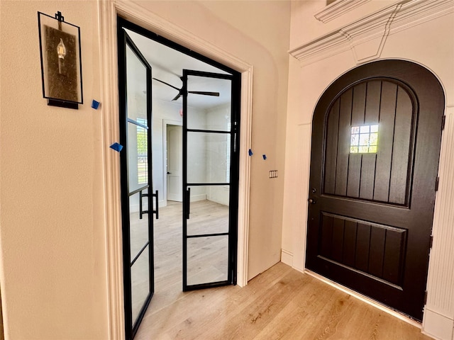 entryway with a healthy amount of sunlight, light wood-type flooring, and a ceiling fan