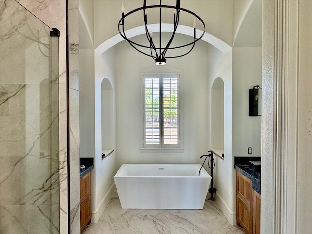 full bath with vanity, a freestanding bath, marble finish floor, and a marble finish shower
