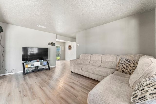 living room with hardwood / wood-style floors and a textured ceiling