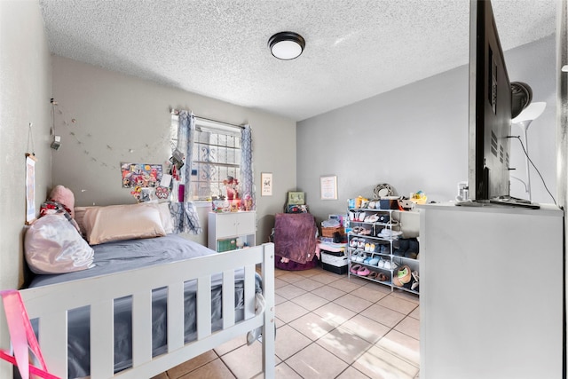 tiled bedroom with a textured ceiling