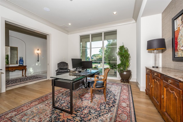 office area with light wood-type flooring and ornamental molding