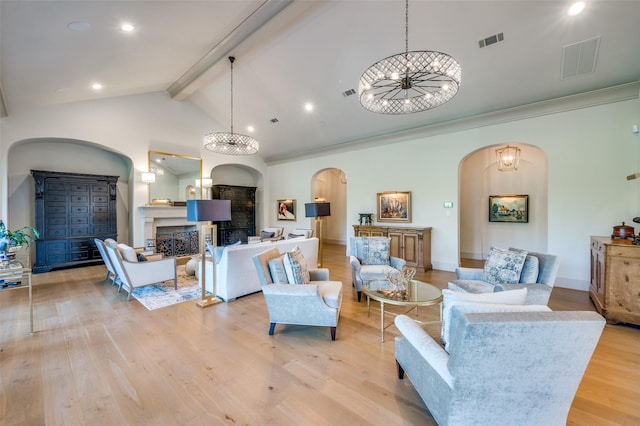 living room with vaulted ceiling with beams, light hardwood / wood-style floors, crown molding, and an inviting chandelier