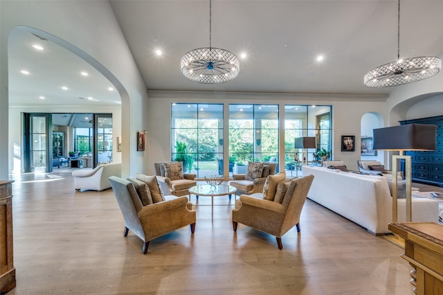 living room featuring light wood-type flooring and a notable chandelier