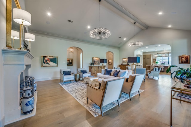 living room featuring beamed ceiling, an inviting chandelier, high vaulted ceiling, and light hardwood / wood-style flooring